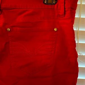 Red New Direction skinny jeans with pocket accents.